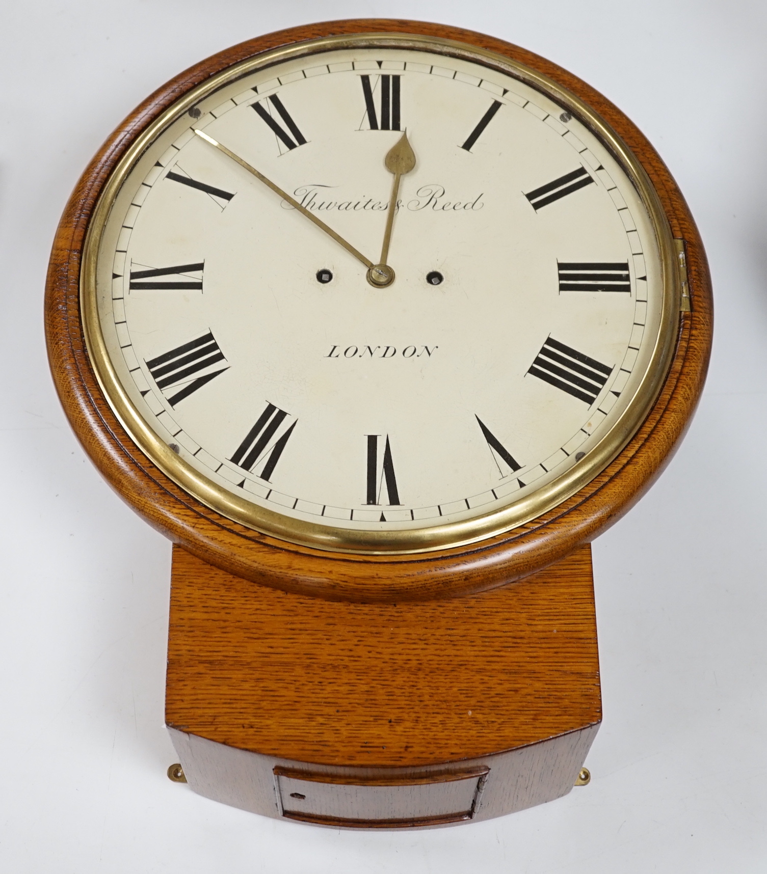 Thwaites and Reed. A Victorian oak drop dial wall clock the twin fusee movement striking on a bell, 44cm high